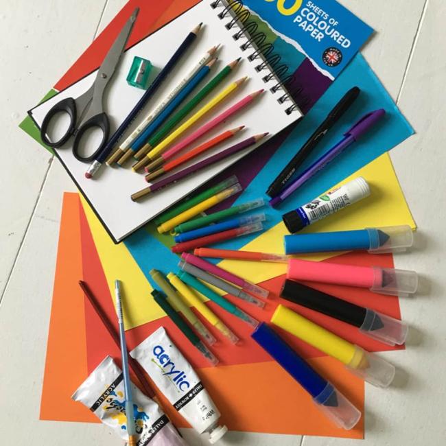 A selection of kids craft activities laid out on a table 