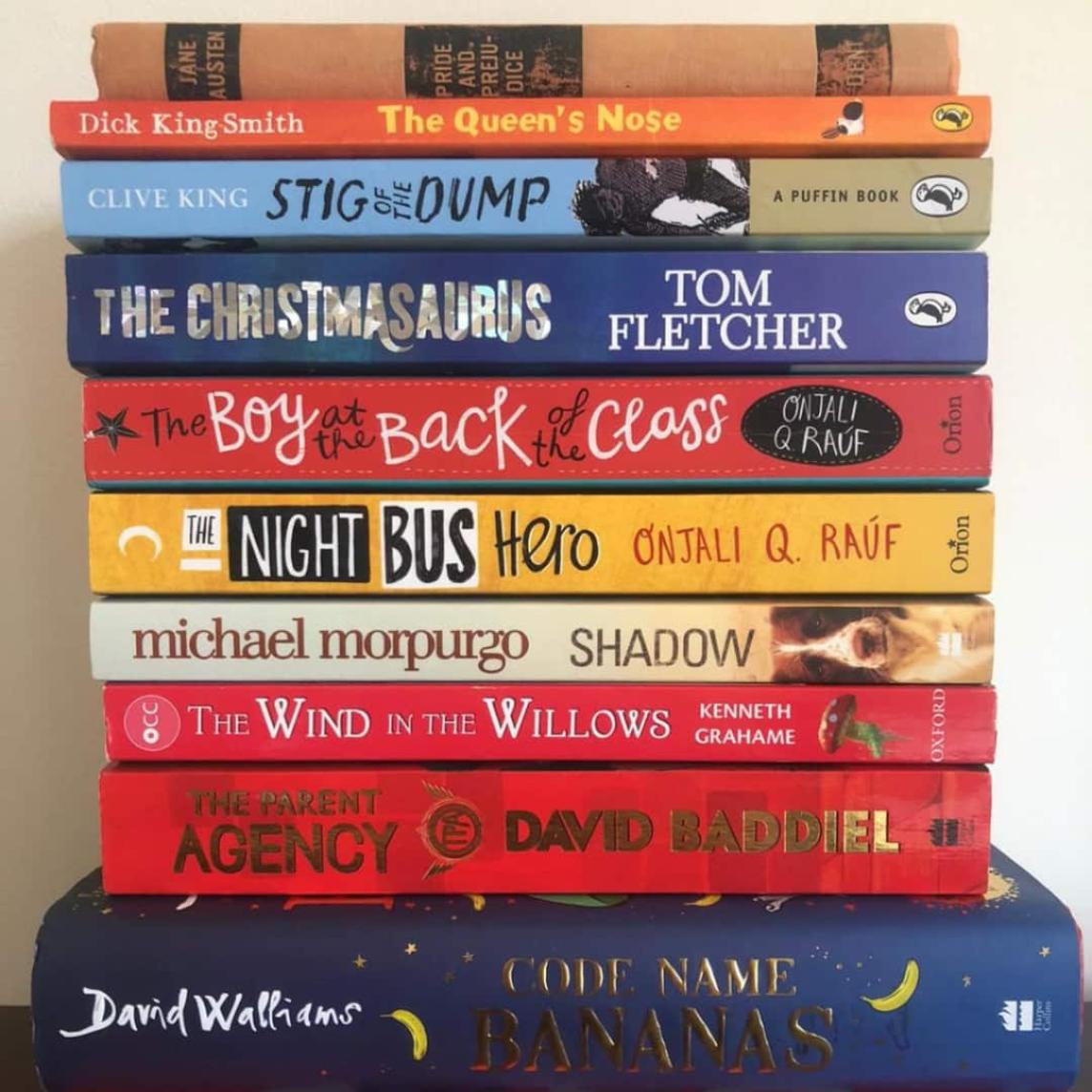 10 neatly piled childrens books
