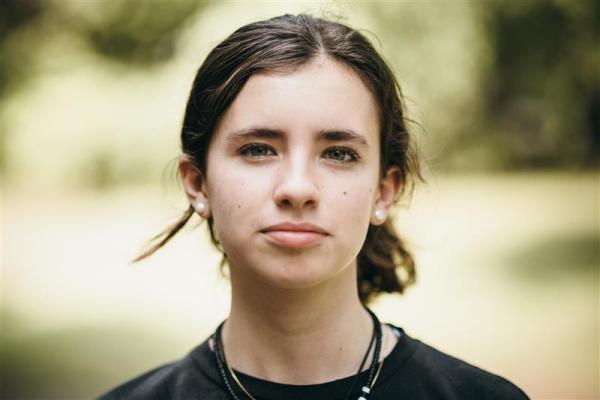 A young girl staring at the camera