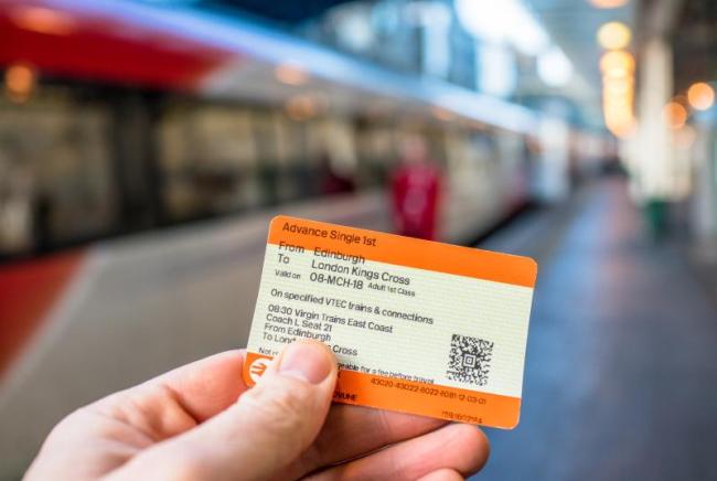 A picture of a hand holding a national rail train ticket