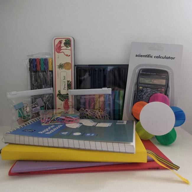 A bundle of school stationery including a calculator and notepads
