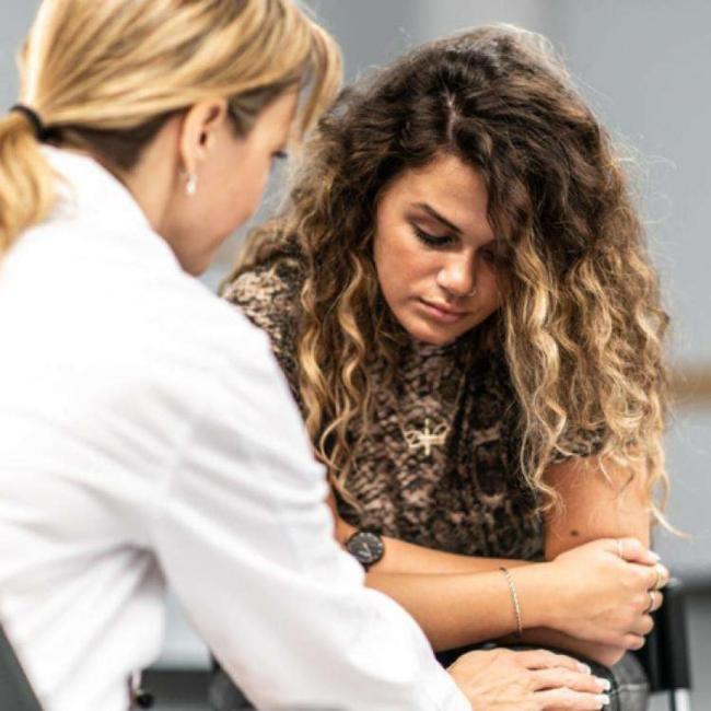 A teenager and her therapist taking part in a therapy session