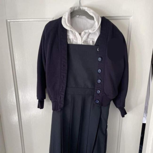 A child's cardigan, polo shirt and dress for school.