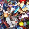 A collection of plastic toys placed on the floor.