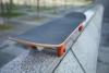 A stationary skateboard resting on a wall 