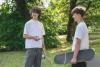 Two young boys holding Skateboards