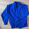 A blue school cardigan jumper placed on a laminated floor