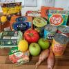 A tabletop full of different fruit, veg and cupboard essentials