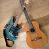 Two guitars on a wooden floor